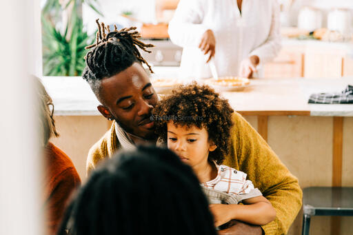 Father and Son Seated at the Table Before Thanksgiving Dessert