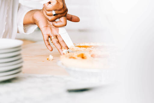 Woman Slicing Pumpkin Pie