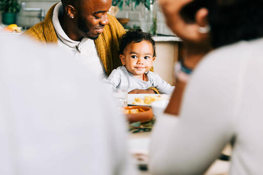Father Holding Baby at the Thanksgiving Table
