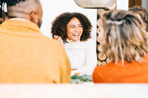 Woman Laughing with Family at the Thanksgiving Table