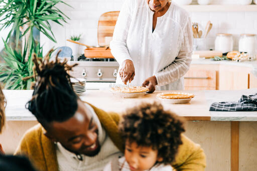 Grandmother Serving and Slicing Pie in the Kitchen