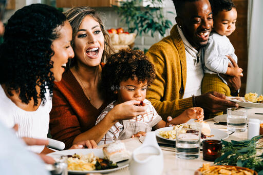 Family Laughing Together at the Thanksgiving Table