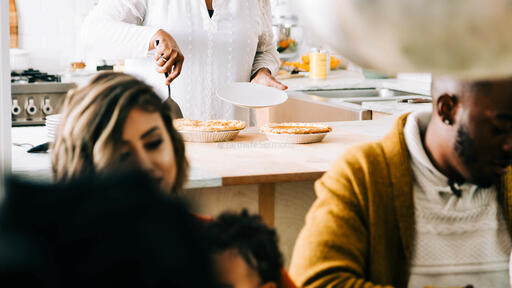 Grandmother Serving and Slicing Pie in the Kitchen