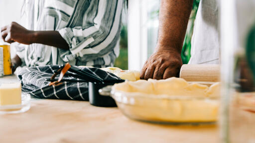Man Rolling out Crust for Apple Pie
