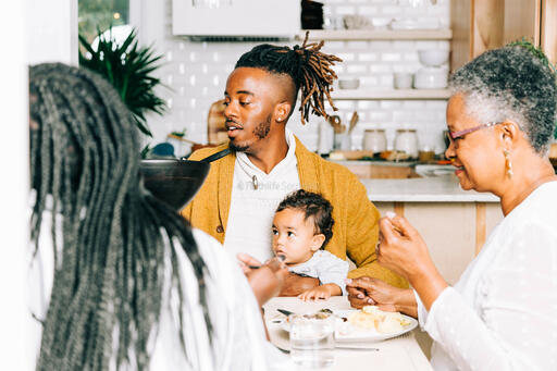 Man Holding Baby at the Thanksgiving Table