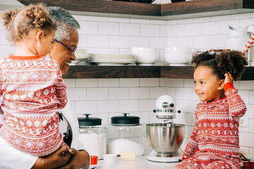 Woman Baking Christmas Cookies with her Grandchildren