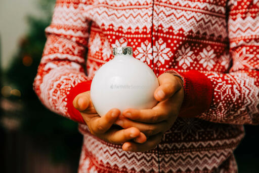 Child Holding a Christmas Ornament