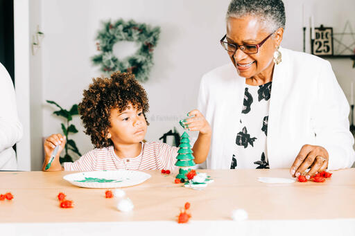 Grandmother and Grandson Doing a Christmas Craft Together