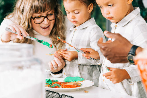 Family Frosting Christmas Cookies Together