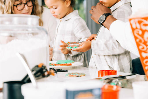 Family Frosting Christmas Cookies Together