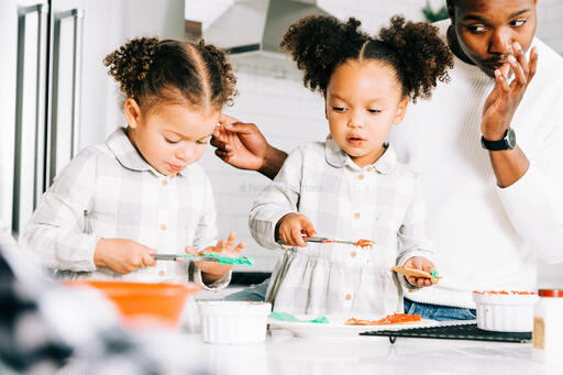 Family Frosting Christmas Cookies Together