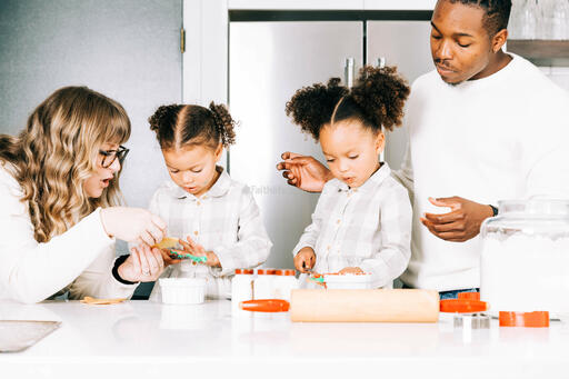 Family Frosting Christmas Cookies Together