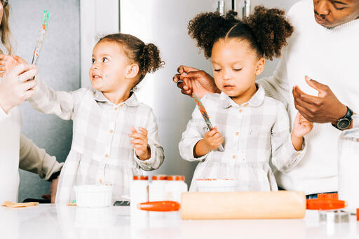 Family Frosting Christmas Cookies Together