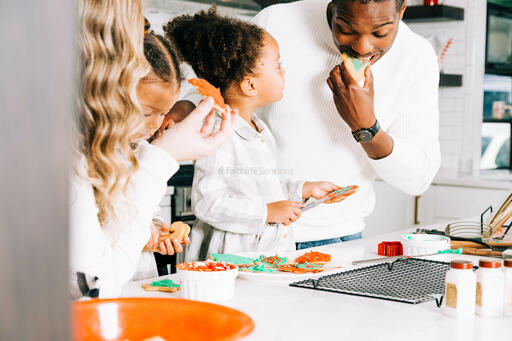 Family Frosting Christmas Cookies Together