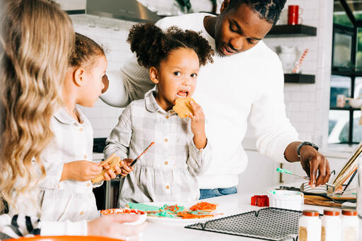 Family Frosting Christmas Cookies Together