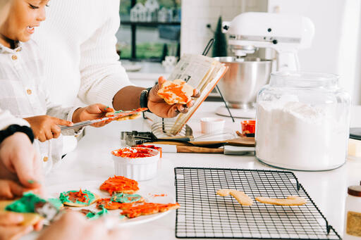 Family Frosting Christmas Cookies Together