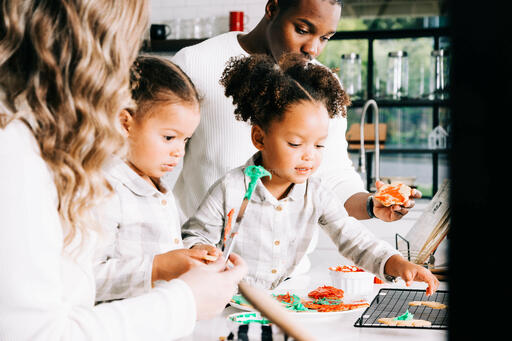 Family Frosting Christmas Cookies Together