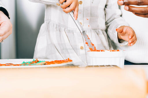 Child Frosting Christmas Cookies