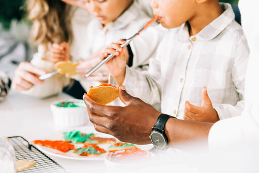 Family Frosting Christmas Cookies Together