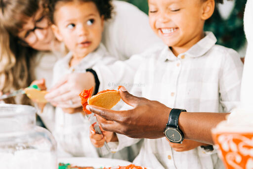 Family Frosting Christmas Cookies Together