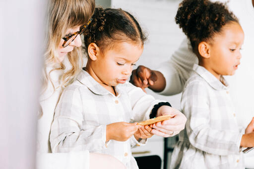 Mother and Daughters Frosting Christmas Cookies