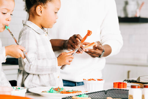 Father and Daughters Frosting Christmas Cookies