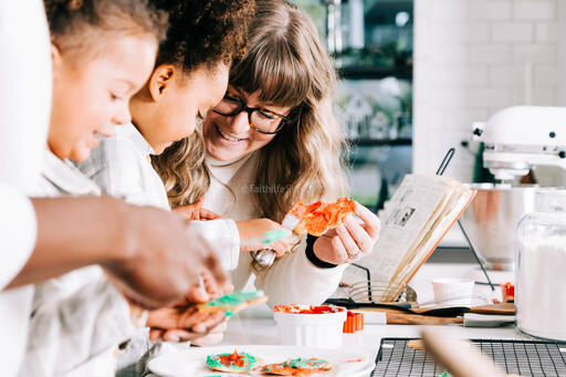 Family Frosting Christmas Cookies Together