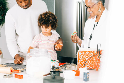 Family Frosting Christmas Cookies Together