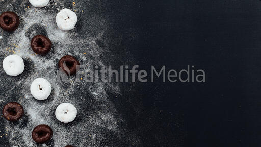 Powdered and chocolate donuts dusted with sugar