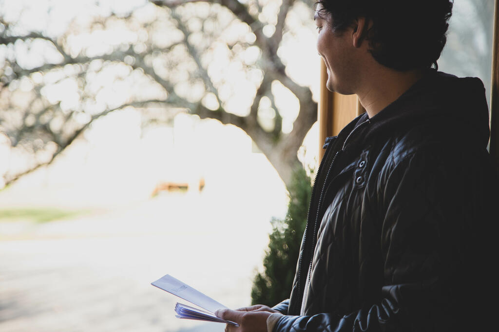 Greeter Standing at Church Entrance with Pamphlets large preview