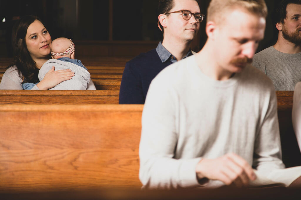Mother Holding Baby During Church Service large preview
