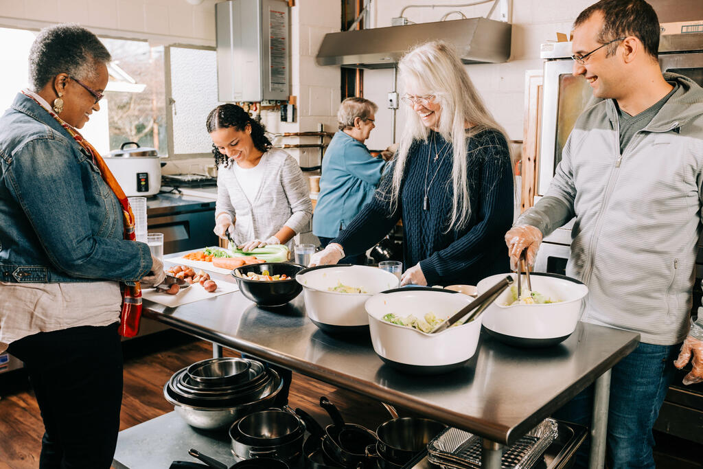 Volunteers Working and Laughing Together in the Kitchen large preview