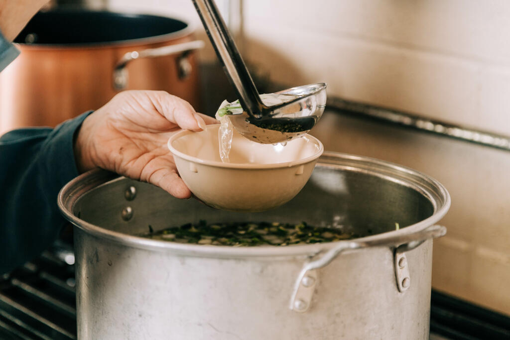 Volunteer Serving Soup at the Soup Kitchen large preview