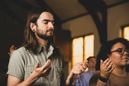 Man with Hands Raised During Worship  image 1