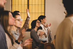 Mother Holding Baby During Worship  image 1