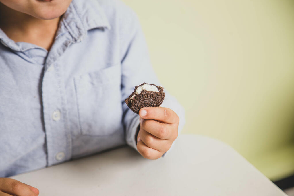 Child Eating an Oreo Cookie large preview