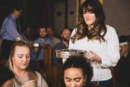 Woman Passing Out Communion  image 1