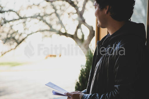 Greeter Standing at Church Entrance with Pamphlets