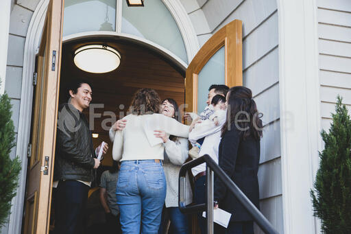 Greeter Hugging a Congregation Member at the Entrance of a Church