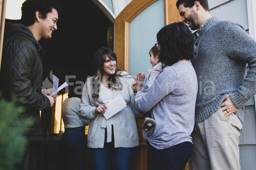 Greeters Welcoming a Young Family to Church