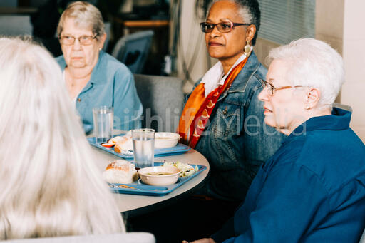 People Sitting Together at a Community Meal