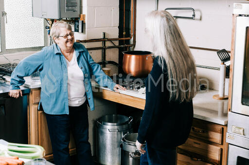 Volunteers Talking While Working in the Soup Kitchen