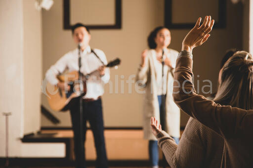 Woman with Her Hands Raised During Worship