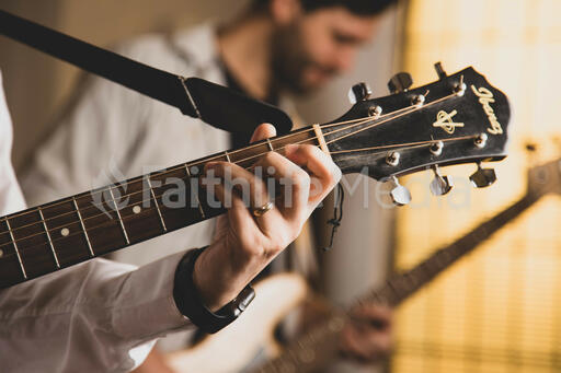 Person Playing Acoustic Guitar