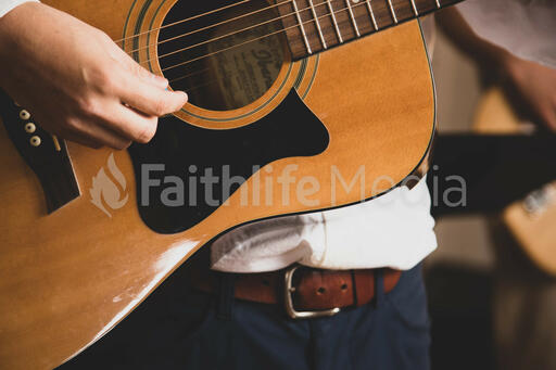 Person Playing Acoustic Guitar