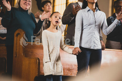 Mother and Daughter Holding Hands During Worship