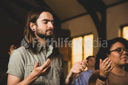 Man with Hands Raised During Worship