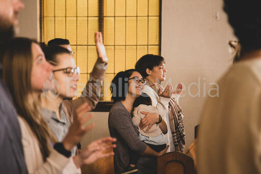 Mother Holding Baby During Worship