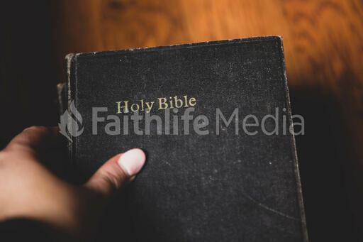 Hand Grabbing a Bible