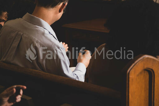 Man Taking Communion at Church